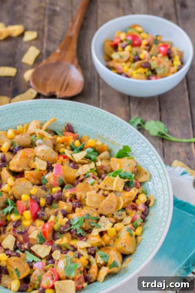 Finished Mexican Potato Salad, garnished with cilantro and corn chips