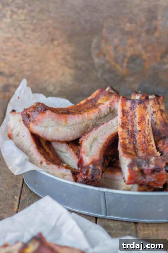 Raw Smithfield Extra Tender Pork Back Ribs generously coated with a rich, homemade dry spice rub, ready for refrigeration and marination. | Strawberry Blondie Kitchen