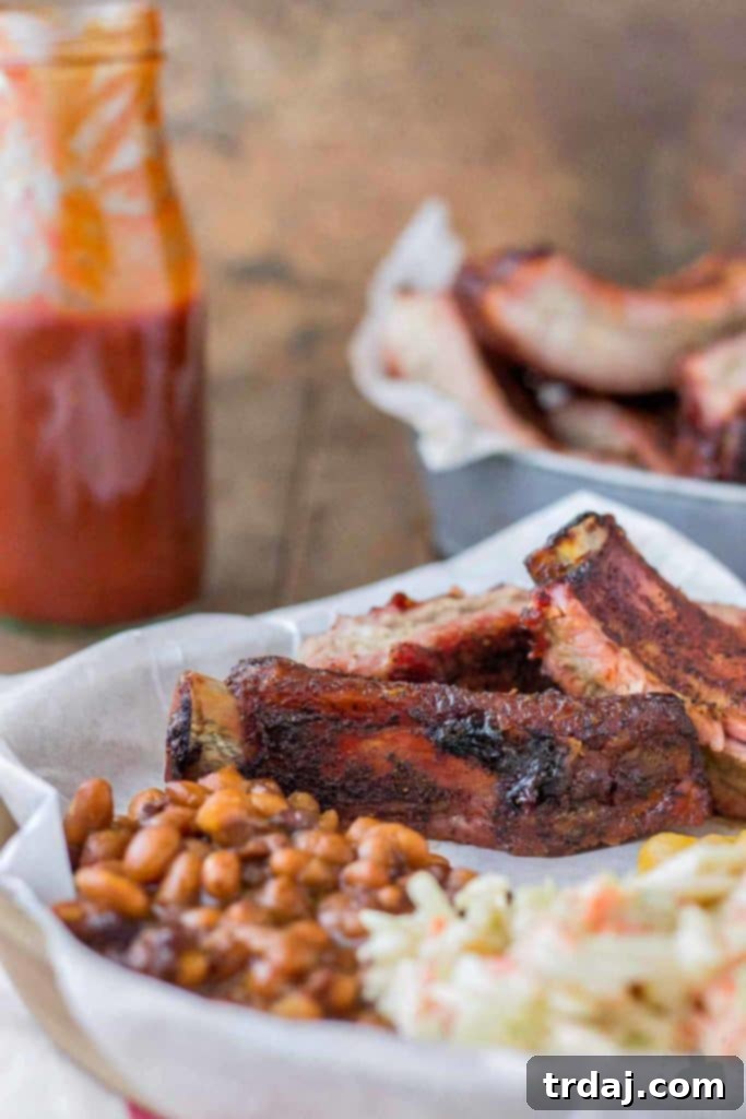 A full plate of expertly grilled Dry Rubbed Pork Ribs, showcasing their golden crust and juicy interior, made with Smithfield Extra Tender Pork Back Ribs. | Strawberry Blondie Kitchen