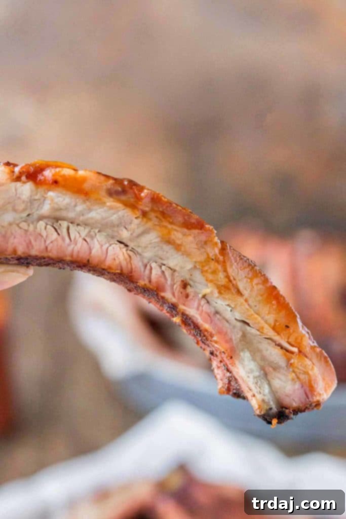 A stunning spread of Dry Rubbed Pork Ribs, expertly grilled and ready for a summer party or family meal, made with Smithfield Extra Tender Pork Back Ribs. | Strawberry Blondie Kitchen