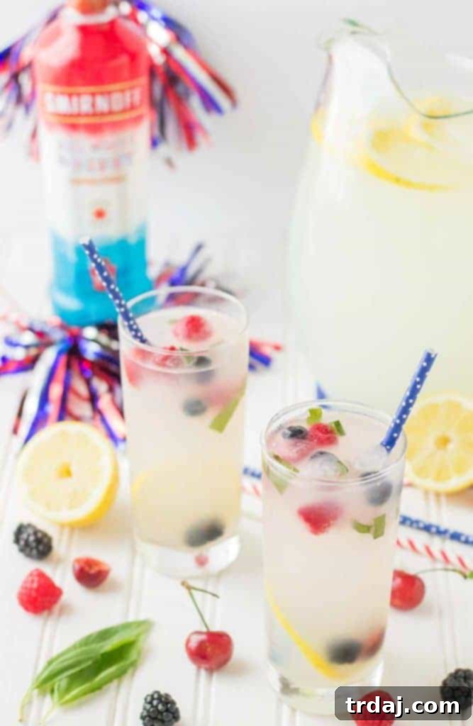 Final presentation of Spiked Triple Berry Basil Lemonade in a tall glass, garnished with fresh berries and basil.