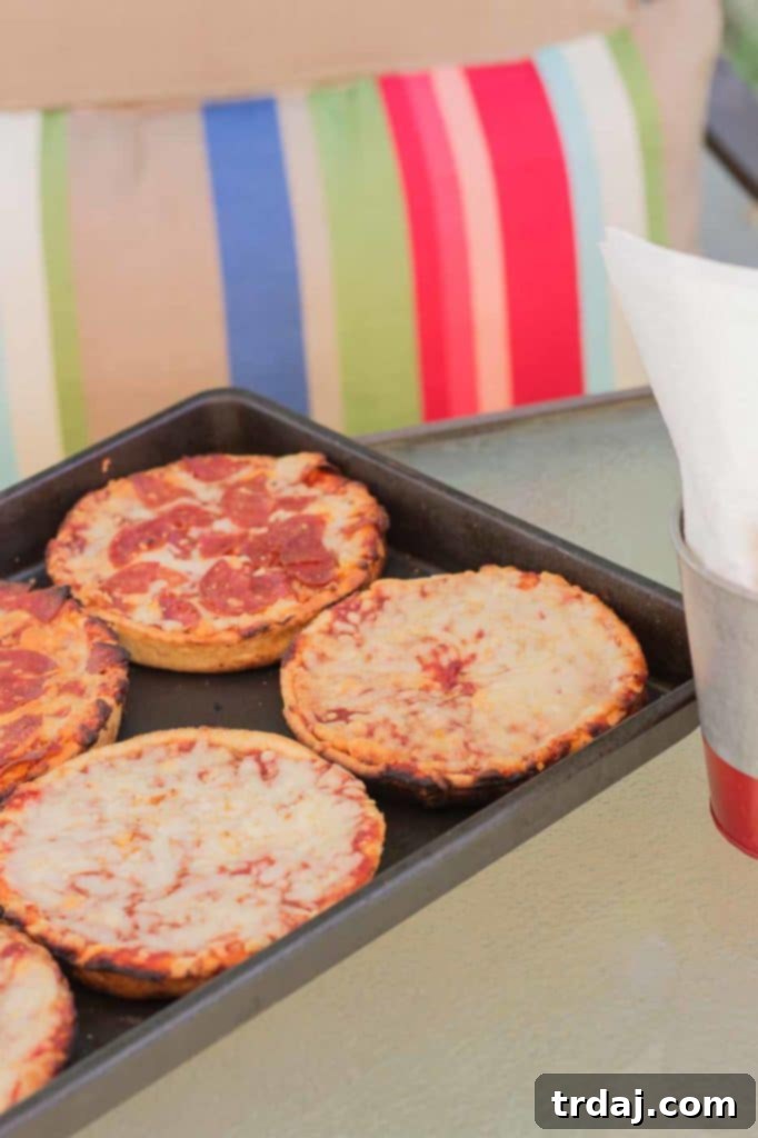 Grilled Red Baron Deep Dish Pizza cooking on an outdoor grill, ready for a summer party.