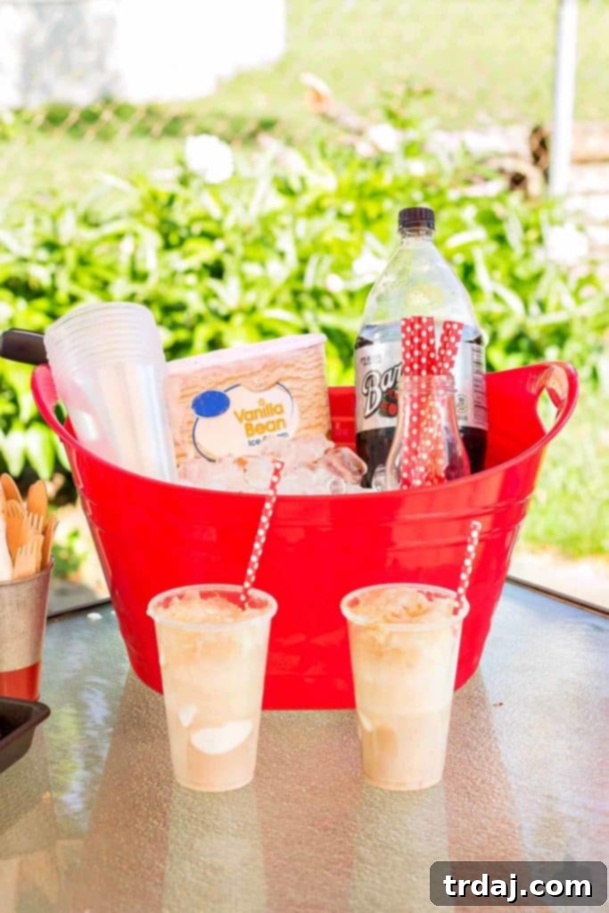 A close-up of a root beer float with a straw, accompanied by slices of grilled pizza.