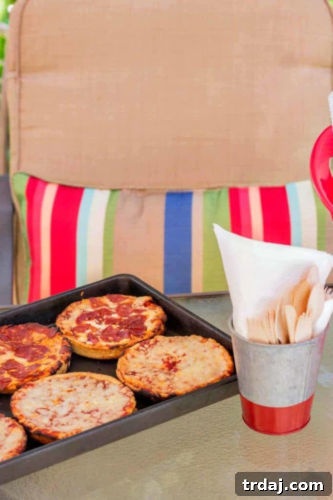 Two hands holding a single Red Baron Deep Dish Pizza before grilling, showcasing its readiness.