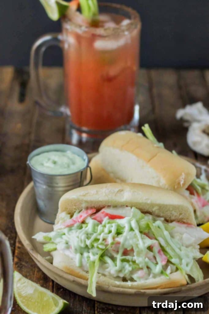A Spicy Seafood Po' Boy sandwich, garnished and ready to eat, served alongside a Spicy Michelada. Discover this delicious brunch pairing.