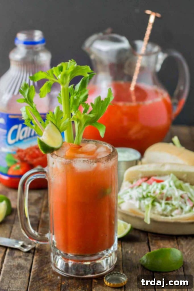 Spicy Wasabi Michelada being poured into a rimmed glass, showcasing the perfect presentation for summer entertaining.