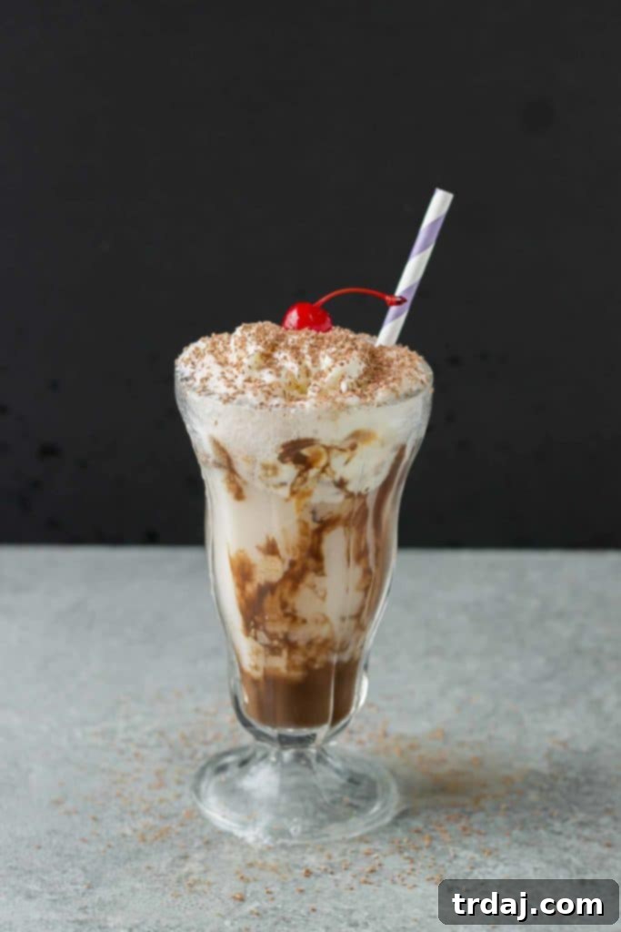 Chocolatey, fizzy, and with swirls of caramel delight ice cream, this Chocolatey Caramel Delight Fizzy Soda will help you beat the heat! | Strawberry Blondie Kitchen
