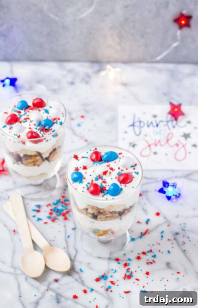 Close-up of Festive Patriotic Mini Trifles, layered with cake, frosting, Snickers, and M&M's