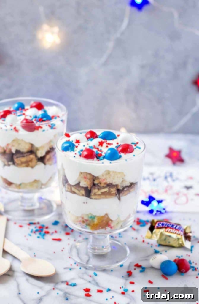 Delicious Layers of Red, White, and Blue in a Mini Trifle, featuring Funfetti cake, frosting, Snickers, and M&M's