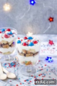Layers of Pillsbury™ Funfetti® Cake, Frosting, Snickers and M&M’s make these Patriotic Mini Trifles the best way to spread your love of Red, White and Blue! | Strawberry Blondie Kitchen