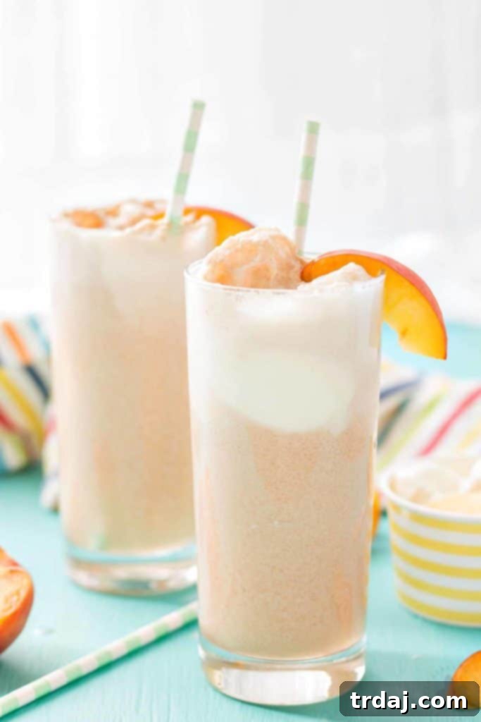 Close-up of a glass of Peaches and Cream Soda with ice cream and peach slices, showcasing its refreshing appeal.