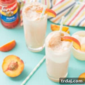 A glass of homemade Peaches and Cream Soda, ready to be enjoyed.