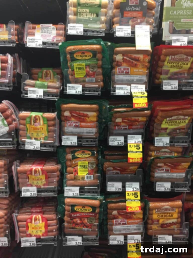 Windy City Smoked Italian Sausage Sliders 4 A hand reaching for a Chicago Style Italian Smoked Sausage Slider, highlighting its appealing presentation.