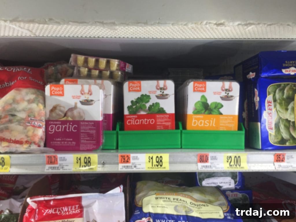 A selection of Pop & Cook frozen herb cubes: cilantro, garlic, and ginger, ready for use in cooking.