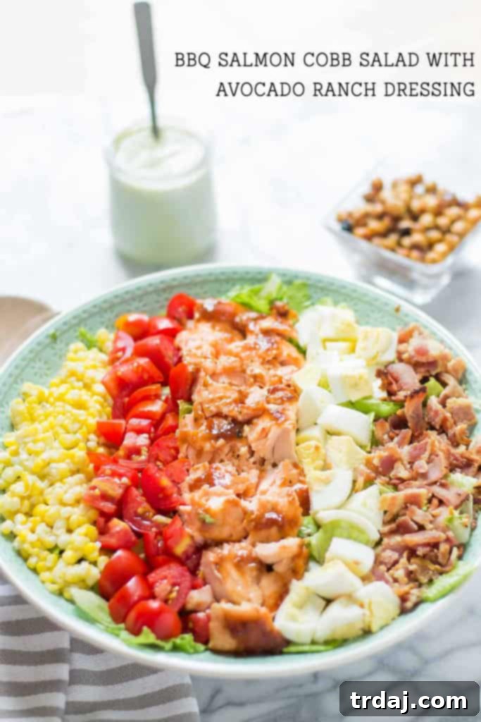 A vibrant and fresh BBQ Salmon Cobb Salad, ready to be enjoyed, showcasing the colorful array of ingredients.