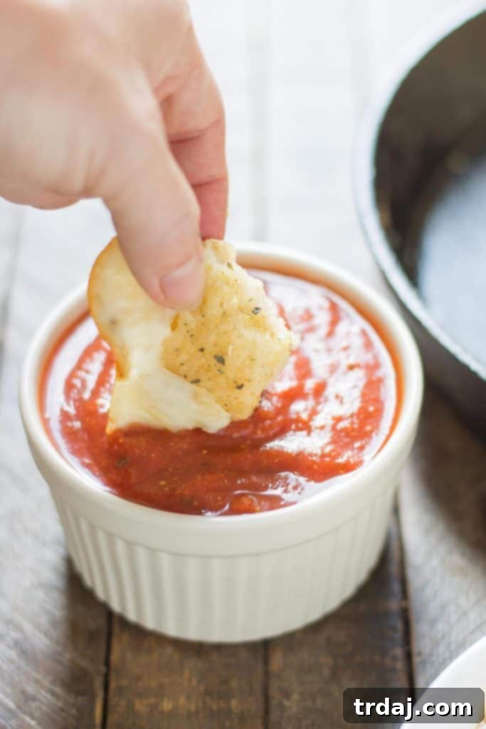 Mouthwatering Garlic Cheese Bites 7 Melted mozzarella cheese pulling apart from a warm garlic cheese bomb, showcasing its gooey interior