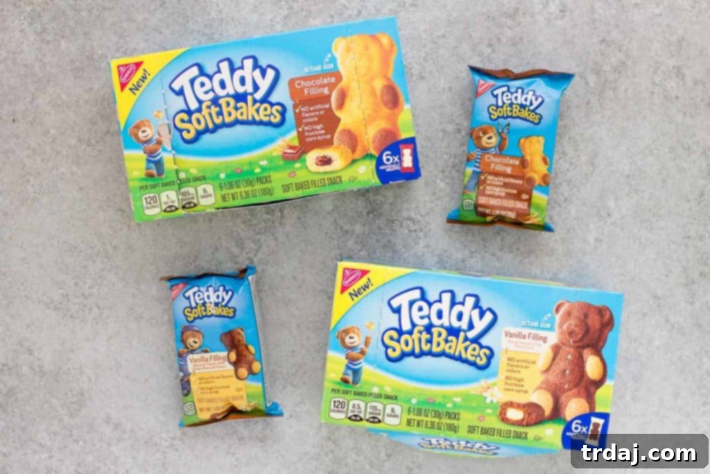 A child's hand holding a TEDDY SOFT BAKED Filled Snack, ready for a delicious bite.