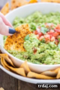 All the flavors you love of guacamole with an added boost of protein and fiber make this Edamame Guacamole super flavorful and a good for you dip. Paired with homemade smoky tortilla chips and you've got one delicious snack. | Strawberry Blondie Kitchen