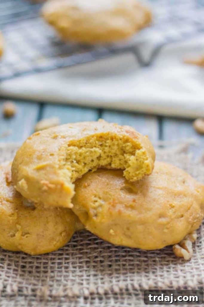 Puffy, cake-like Pumpkin Nut Cookies with walnuts and warming spices, perfect for Fall gatherings