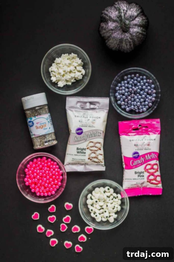 Sparkling Pink-O-Ween Candy Bark Toppings Close-up of Pink-O-Ween Candy Bark with various pink, silver, and black toppings.