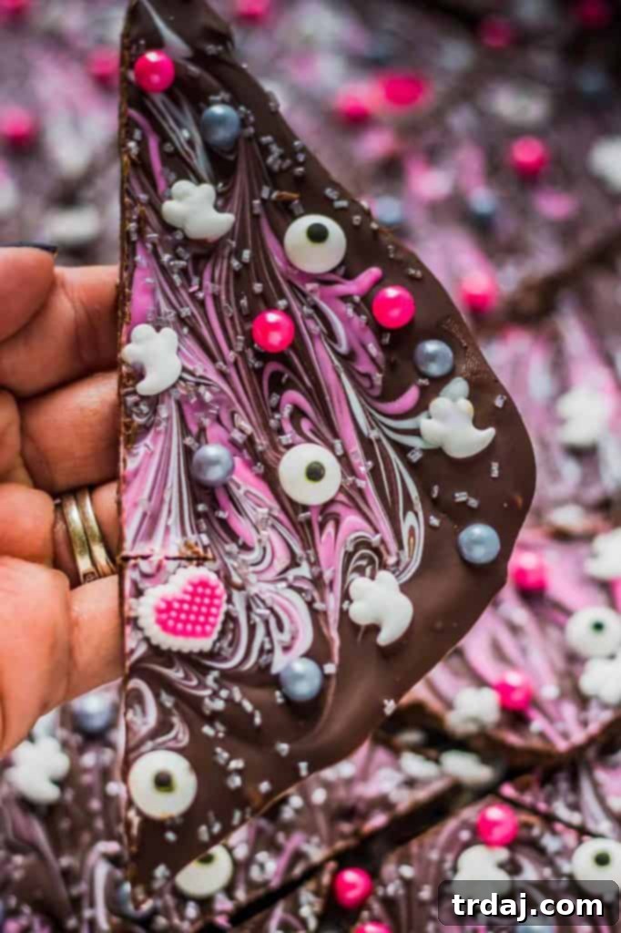 Serveable Pink-O-Ween Candy Bark A festive piece of Pink-O-Ween Candy Bark on a plate.