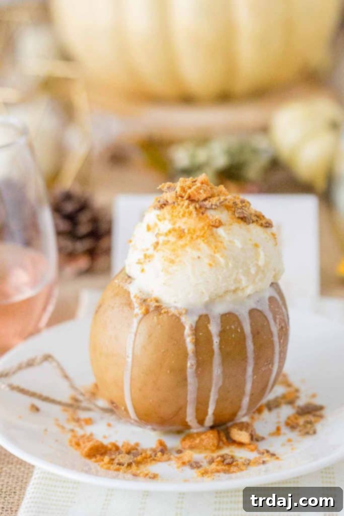 Warm Butterfinger Stuffed Apple topped with vanilla ice cream and extra Butterfinger pieces