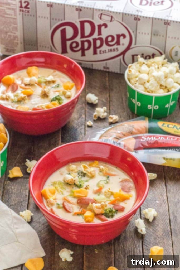 Close-up of creamy Smoked Sausage and Beer Cheese Soup with herbs