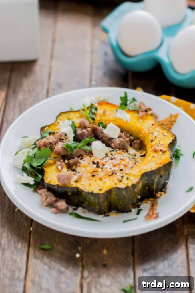 Close-up of cracked eggs in roasted acorn squash before baking