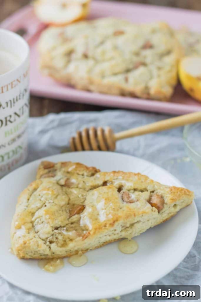 Soft and sweet, with pillows of pear and rich blue cheese and a drizzle of honey, these Pear and Blue Cheese Scones are the perfect pair with your morning cup of coffee! | Strawberry Blondie Kitchen