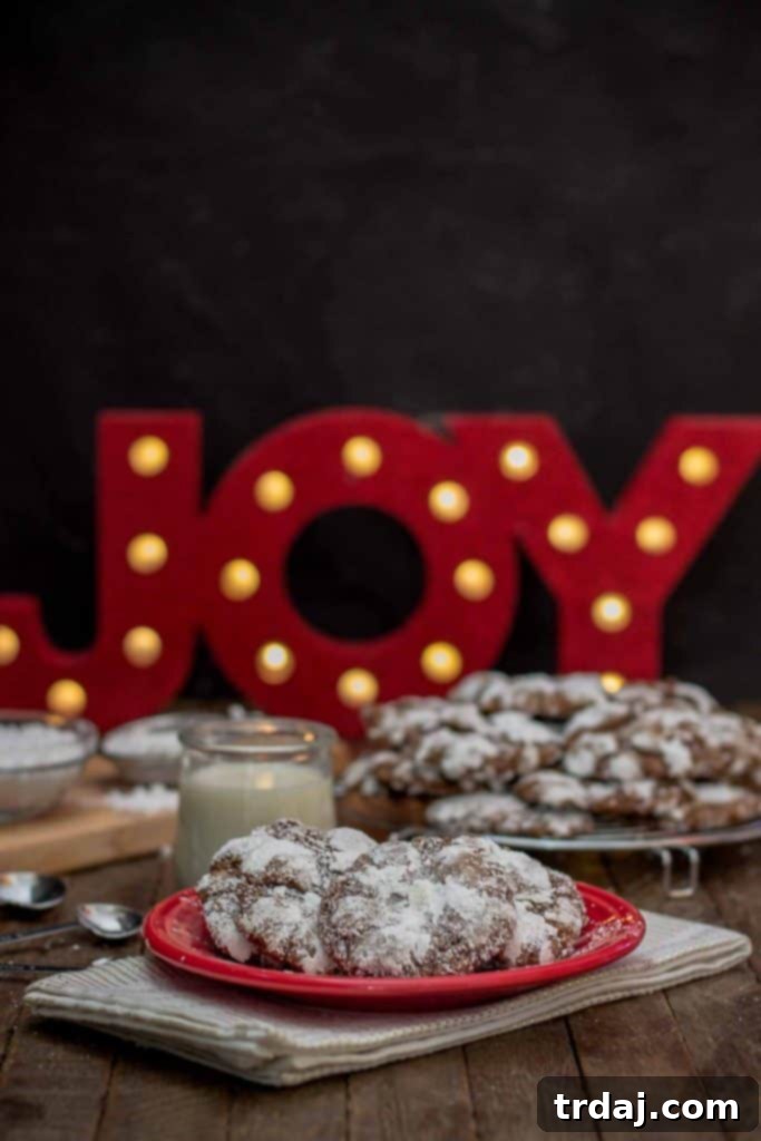 Delicious Peppermint Crinkle Cookies with powdered sugar, perfect for holiday gatherings and Christmas baking.