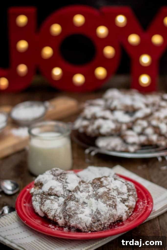A festive close-up of Peppermint Crinkle Cookies, showcasing their delightful powdered sugar coating and inviting texture.
