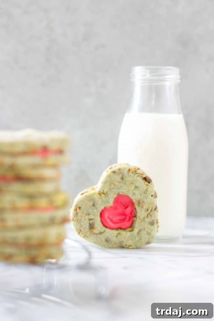 Beautifully arranged Grinch Sandwich Cookies, showcasing their vibrant green and red festive colors, ready to be served for holiday celebrations. A perfect Christmas dessert.