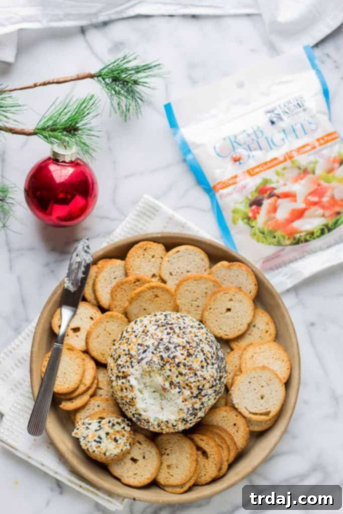 A close-up of the Crab and Everything Bagel Cheese Ball, featuring its appealing texture and seasoned crust, ready for serving.