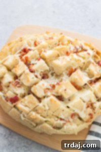 Cheddar Bacon Ranch Pull Apart Bread, golden brown and bubbly, presented on a platter.