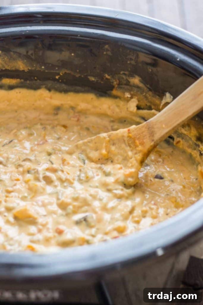 Philly Cheesesteak Dip bubbling in a slow cooker, ready to serve