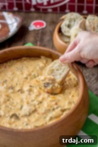 Slow Cooker Philly Cheesesteak Dip served with baguette slices