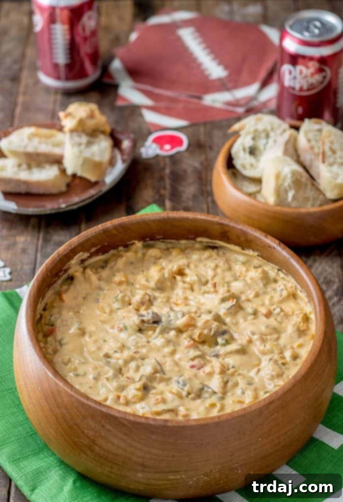 Slow Cooker Philly Cheesesteak Dip served with sliced baguettes and Dr Pepper