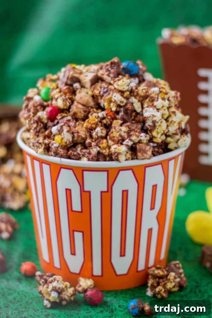Rocky Road to Victory Popcorn is a game day lovers dream. Rich chocolate, salty popcorn and bits of candy pieces make this popcorn mix a must have at your next home gate! | Strawberry Blondie Kitchen