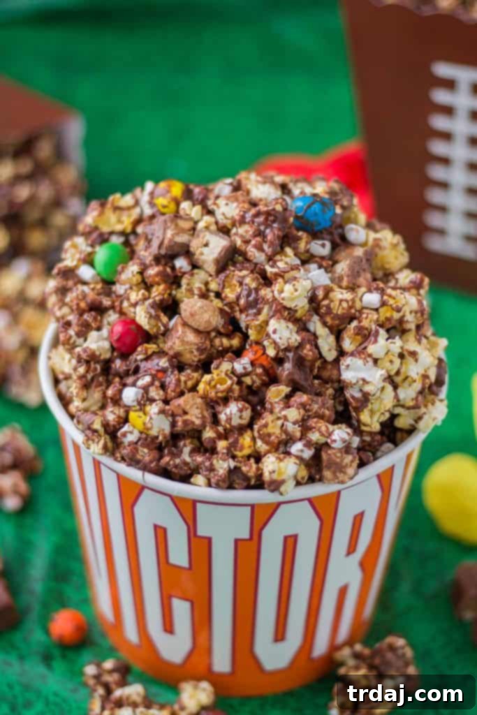 Rocky Road to Victory Popcorn is a game day lovers dream. Rich chocolate, salty popcorn and bits of candy pieces make this popcorn mix a must have at your next home gate! | Strawberry Blondie Kitchen