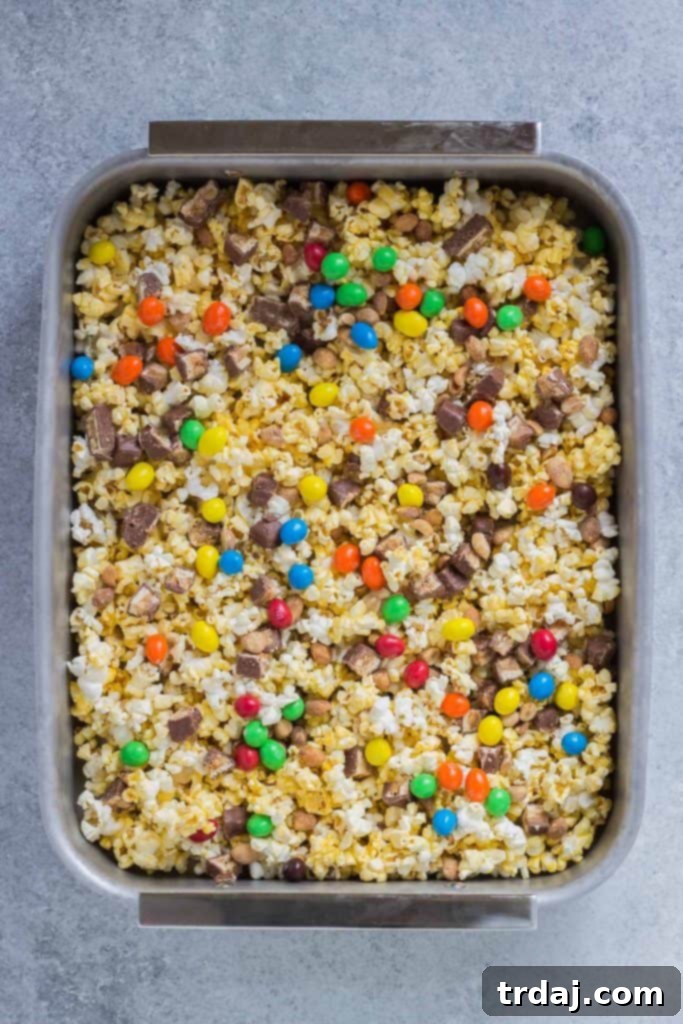 Rocky Road to Victory Popcorn is a game day lovers dream. Rich chocolate, salty popcorn and bits of candy pieces make this popcorn mix a must have at your next home gate! | Strawberry Blondie Kitchen
