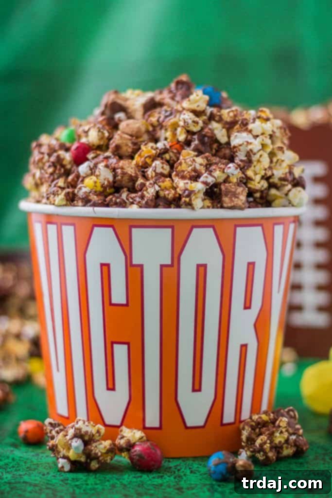Rocky Road to Victory Popcorn is a game day lovers dream. Rich chocolate, salty popcorn and bits of candy pieces make this popcorn mix a must have at your next home gate! | Strawberry Blondie Kitchen