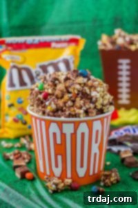 Rocky Road to Victory Popcorn is a game day lovers dream. Rich chocolate, salty popcorn and bits of candy pieces make this popcorn mix a must have at your next home gate! | Strawberry Blondie Kitchen