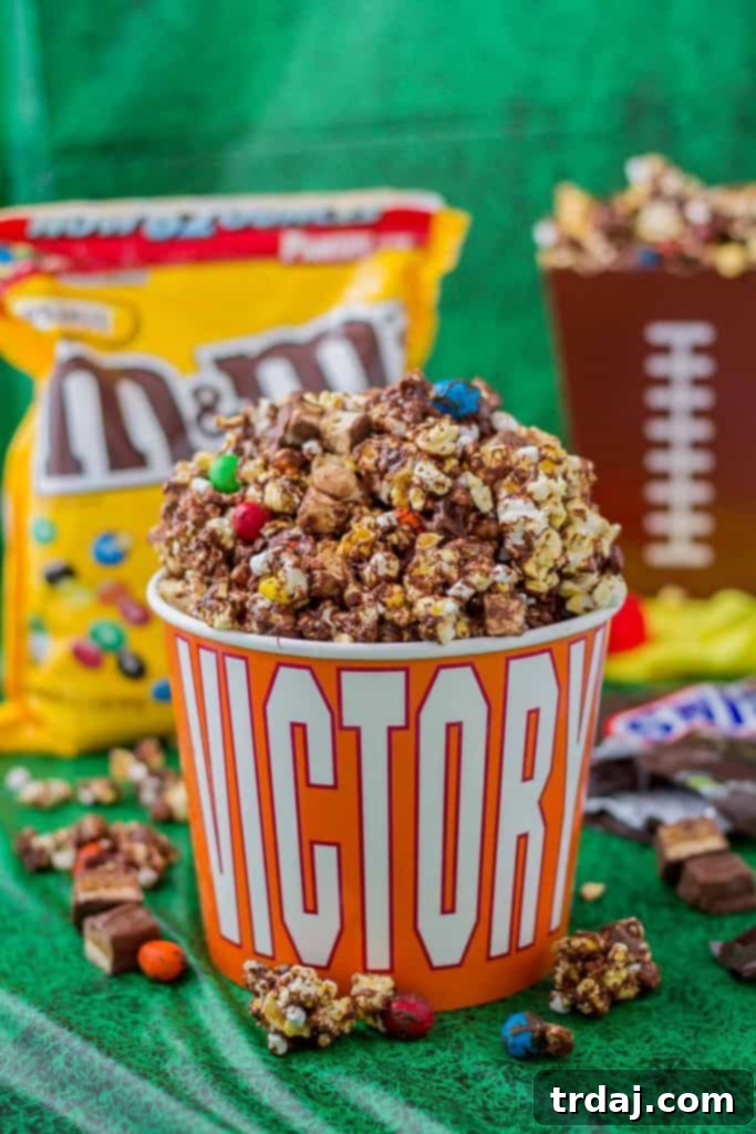Rocky Road to Victory Popcorn is a game day lovers dream. Rich chocolate, salty popcorn and bits of candy pieces make this popcorn mix a must have at your next home gate! | Strawberry Blondie Kitchen