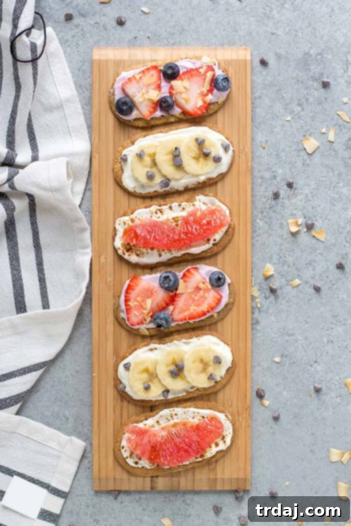 A plate of vibrant Mini Breakfast Biscuit Pizzas featuring belVita biscuits, Dannon Oikos Triple Zero yogurt, and fresh fruit toppings.
