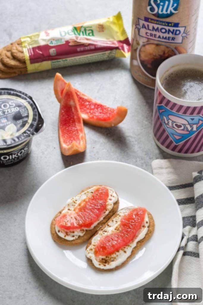 Overhead shot of two Mini Breakfast Biscuit Pizzas, one with strawberries and blueberries, the other with banana and chocolate chips.