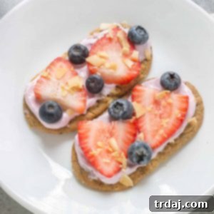 A beautifully arranged Mini Breakfast Biscuit Pizza with various colorful toppings.