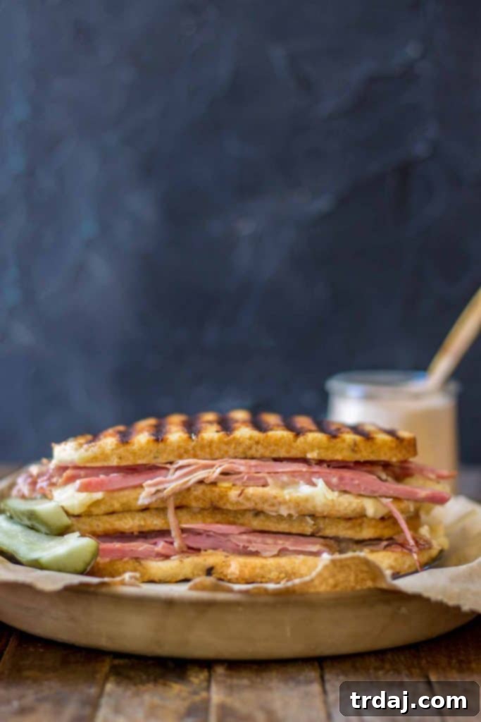 A stacked Epic Reuben Sandwich, showcasing layers of ingredients and golden-brown bread