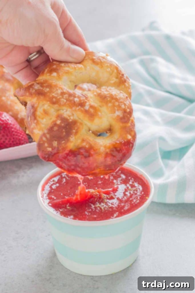 Homemade Soft Pretzels with Strawberry Margarita Sauce A beautiful platter of golden homemade Soft Pretzels with a small bowl of Strawberry Margarita Sauce for dipping. The perfect shareable snack.