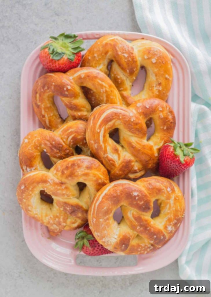 Soft Pretzels: Enjoy Them Sweet or Savory A rustic shot of homemade Soft Pretzels, with a small bowl of Strawberry Margarita Sauce and an option for cheese dip, highlighting their versatility.