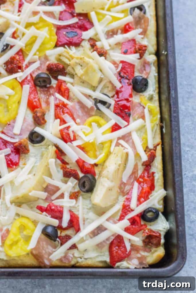 A close-up shot of a single Antipasto Pizza slice, showing its layers